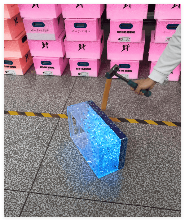 Injection-molded LED ice bucket undergoing a hammer impact test